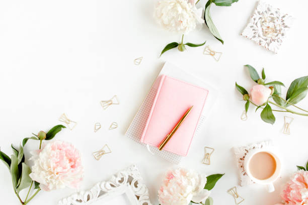 istock Workspace with diary, notebook, accessories, peony flowers on white background. Home office desk. Top view feminine background. Flat lay, top view 1272481115