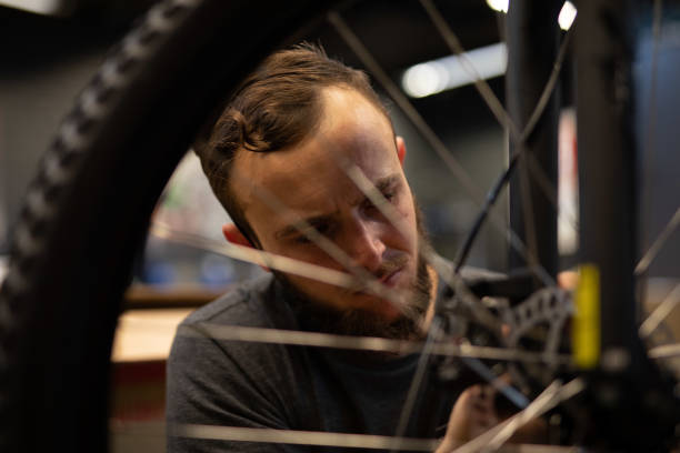 istock A bike mechanic in his workshop. 1272482202