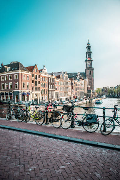 istock Bicycles Parked On Amstel River Bridge And Zuiderkerk Tower In Amsterdam 1272482204