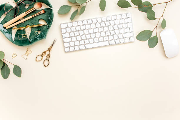 istock Flat lay home office desk. Female workspace with computer, plate sheet monstera, golden accessories, eucalyptus leaves, on beige background. Top view 1272482553
