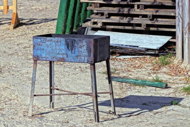istock one old brown iron grill in rust stands on gray sand 1272482697