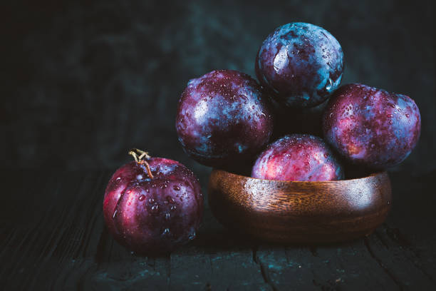 istock Purple plum on black 1272483391