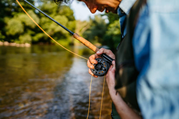 istock Man with a spinning fishing on the river 1272484482