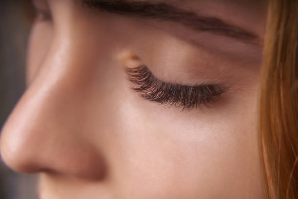 istock Eyelash Extension Procedure. Woman Eye with Long Eyelashes. Close up, selective focus 1272484685
