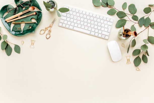 istock Flat lay home office desk. Female workspace with computer, plate sheet monstera, golden accessories, eucalyptus leaves, on beige background. Top view 1272484851