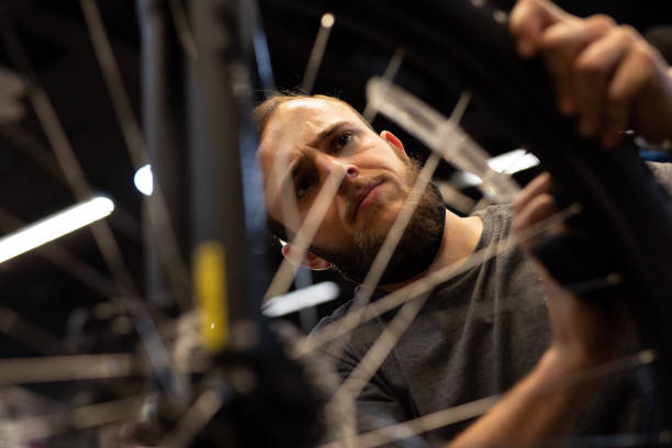 istock A bike mechanic in his workshop. 1272485038