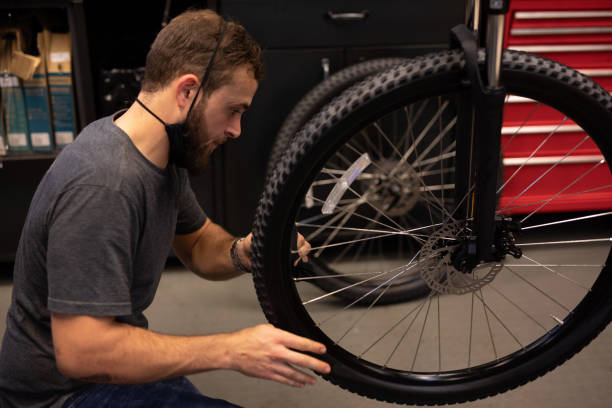 istock A bike mechanic in his workshop. 1272485066
