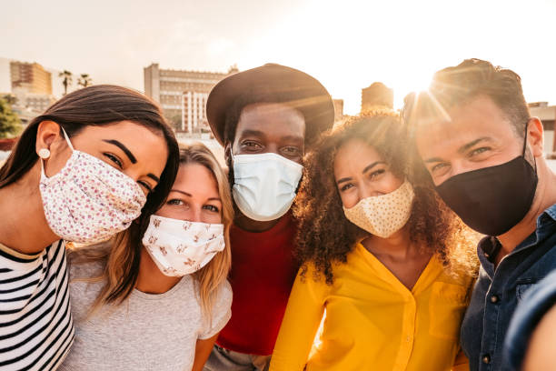 istock Friends making selfie with face masks on 1272487071