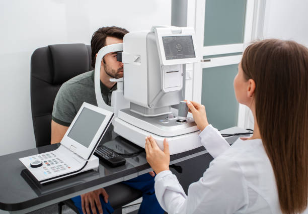 istock Woman ophthalmologist using autorefractor calculate the vision correction a man patient's in a modern ophthalmic clinic 1272487129