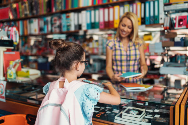 istock Mother and daughter in a bookstore 1272487211