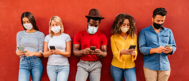 istock Five young people using phones next to each other 1272487297