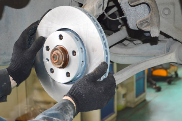 istock Mechanic changes the brake discs and pads on the car 1272492470