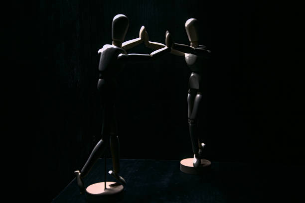 istock Drawing mannequins that struggle to push each other by their arms 1272492559