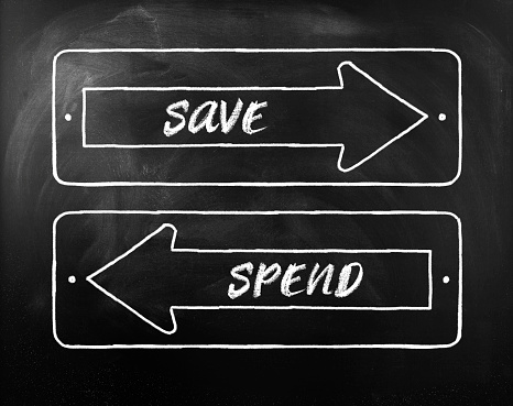 Choice Save or Spend written on opposite arrows on Blackboard