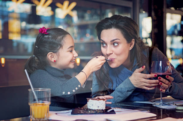 istock Daughter is feeding her mother with a cake 1272493783