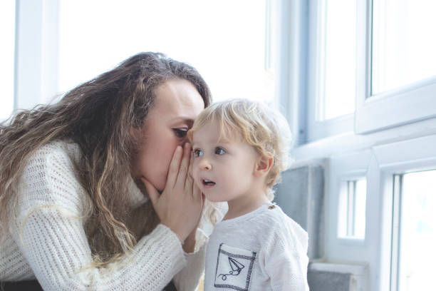 istock confused little boy talking to his mother 1272496721