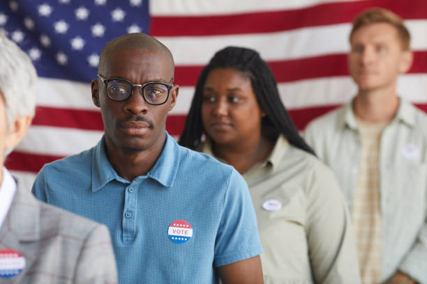 istock Group of Voters Standing in Row 1272497369