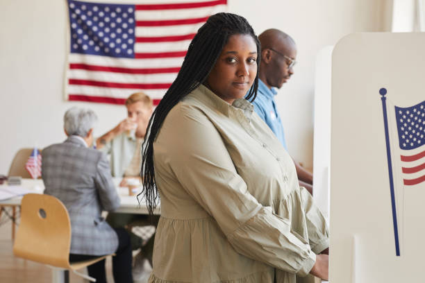 istock African-American Woman in Voting Booth 1272497415