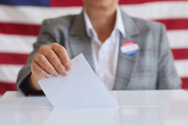 istock Mature Woman Voting Close Up 1272497423