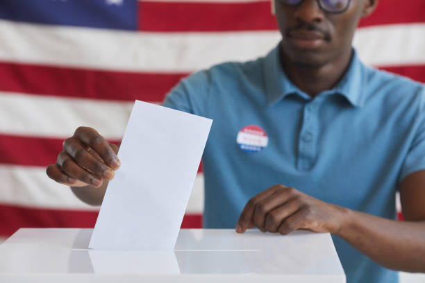 istock African Man Putting Vote in Ballot Box Close Up 1272497428
