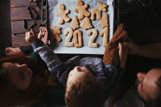 istock Little boy and parents with gingerbread cookies 1272499796