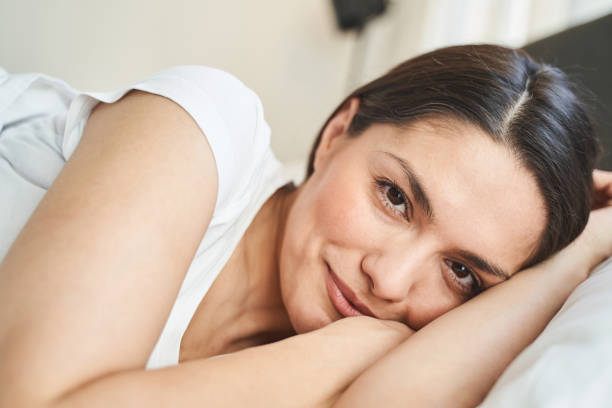 istock Serene young woman smiling after waking up 1272500037