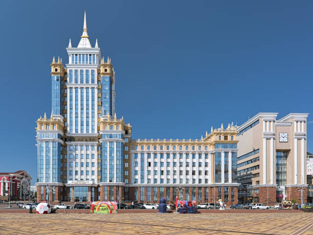 Main building of Mordovian State University in Saransk, Russia Saransk, Russia - August 16, 2018: The main building of Mordovian State University. The 90 meters height 17-storey building with spire was opened on September 15, 2016. It is the tallest building in the city. Fragment of the Opera and Ballet Theater of Saransk is visible on the left. mordovia stock pictures, royalty-free photos & images