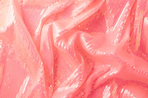 Large shiny glossy coral sequins background. Photography on the theme of the trend color 2019. Large shiny glossy orange sequins fully filling the background space. red tiger lily stock pictures, royalty-free photos & images
