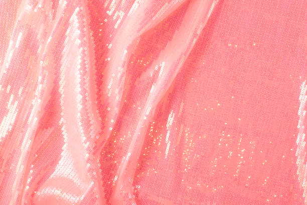 Large shiny glossy pink sequins background. Photography on the theme of the trend color 2019. Large shiny glossy orange sequins fully filling the background space. red tiger lily stock pictures, royalty-free photos & images