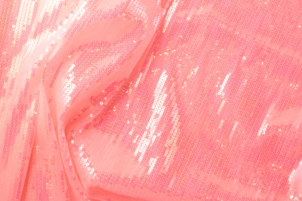 Large shiny glossy pink sequins background. Photography on the theme of the trend color 2019. Large shiny glossy orange sequins fully filling the background space. red tiger lily stock pictures, royalty-free photos & images