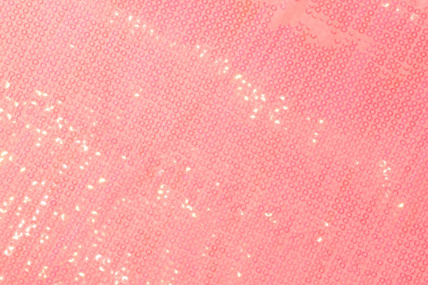 Large shiny glossy pink sequins background. Photography on the theme of the trend color 2019. Large shiny glossy orange sequins fully filling the background space. red tiger lily stock pictures, royalty-free photos & images