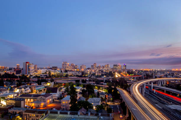 Oakland, California, Dusk Cityscape of Oakland, looking West. alameda county stock pictures, royalty-free photos & images