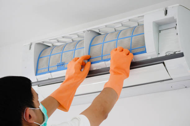istock Asian man cleaning air conditioner dirty filter 1272506061