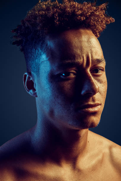 istock Young adult guy looking at camera with serious face 1272506297
