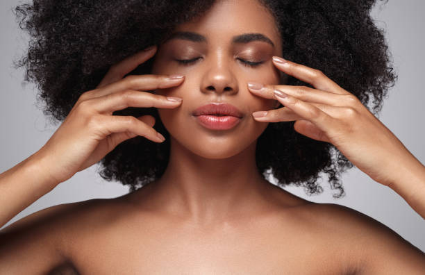 istock Ethnic woman applying cream on face 1272506722
