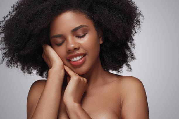 istock Glad ethnic woman touching skin on cheek 1272506731
