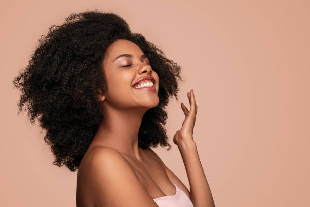 istock Delighted black woman enjoying skin cleanness 1272506749