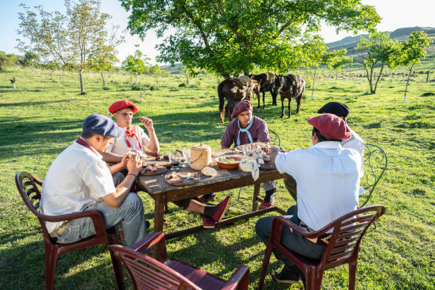 istock Young gauchos relaxing over outdoor midday meal 1272507048