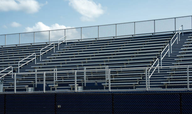 Empty Sports Stadium Due to Pandemic Empty benches in sports stadium.  Represents lockdown in sports due to coronavirus. bleachers stock pictures, royalty-free photos & images