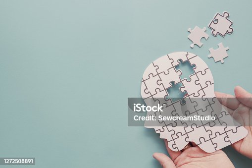 istock Hands holding brain with puzzle paper cutout, autism, Epilepsy and alzheimer awareness, seizure disorder, world mental health day concept 1272508891
