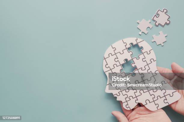 Hands Holding Brain With Puzzle Paper Cutout Autism Epilepsy And Alzheimer Awareness Seizure Disorder World Mental Health Day Concept Stock Photo - Download Image Now