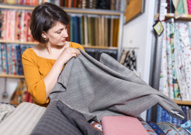 istock Woman choosing textiles in shop 1272509699