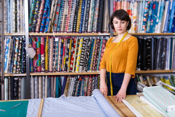 istock Woman seller of tissue store near cutting table 1272509708