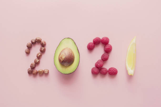 2021 made from healthy food on pink background, Happy New year, health diet resolution, goals and lifestyle 2021 made from healthy food on pink background, Happy New year, health diet resolution, goals and lifestyle paleo diet photos stock pictures, royalty-free photos & images