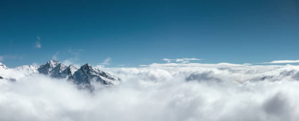Above The Fog Majestic snowcapped mountains in France (Val Thorens). View from Cime Caron (3200m). dramatic landscape photos stock pictures, royalty-free photos & images