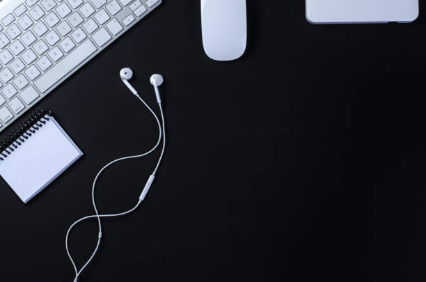 istock Top view of office work space, black desk table with keyboard, mouse, notebook and external hard drive. With a copy space, flat lay 1272515178