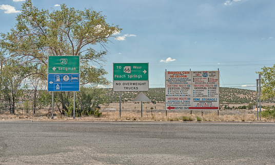 Seligman, Arizona - USA:Travelers pull off the highway Near Seligman  and check out the direction signs as well as the information sign this information is available for the travelers benefit and on this July day it led to a lunch break.