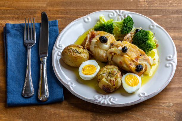 istock Cod loin baked in olive oil, with potatoes, broccoli, boiled egg and black olives. Typical dish of Portugal. 1272521764