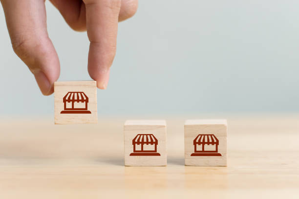 istock Franchise business marketing system concept. Structure service store network strategy. Hand choose wooden block with icon store 1272526461