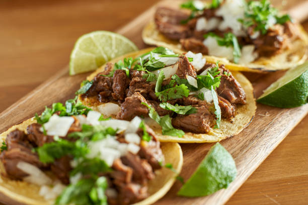 three carne asada mexican street tacos in corn tortilla with lime three carne asada mexican street tacos in corn tortilla with lime close up tacos stock pictures, royalty-free photos & images